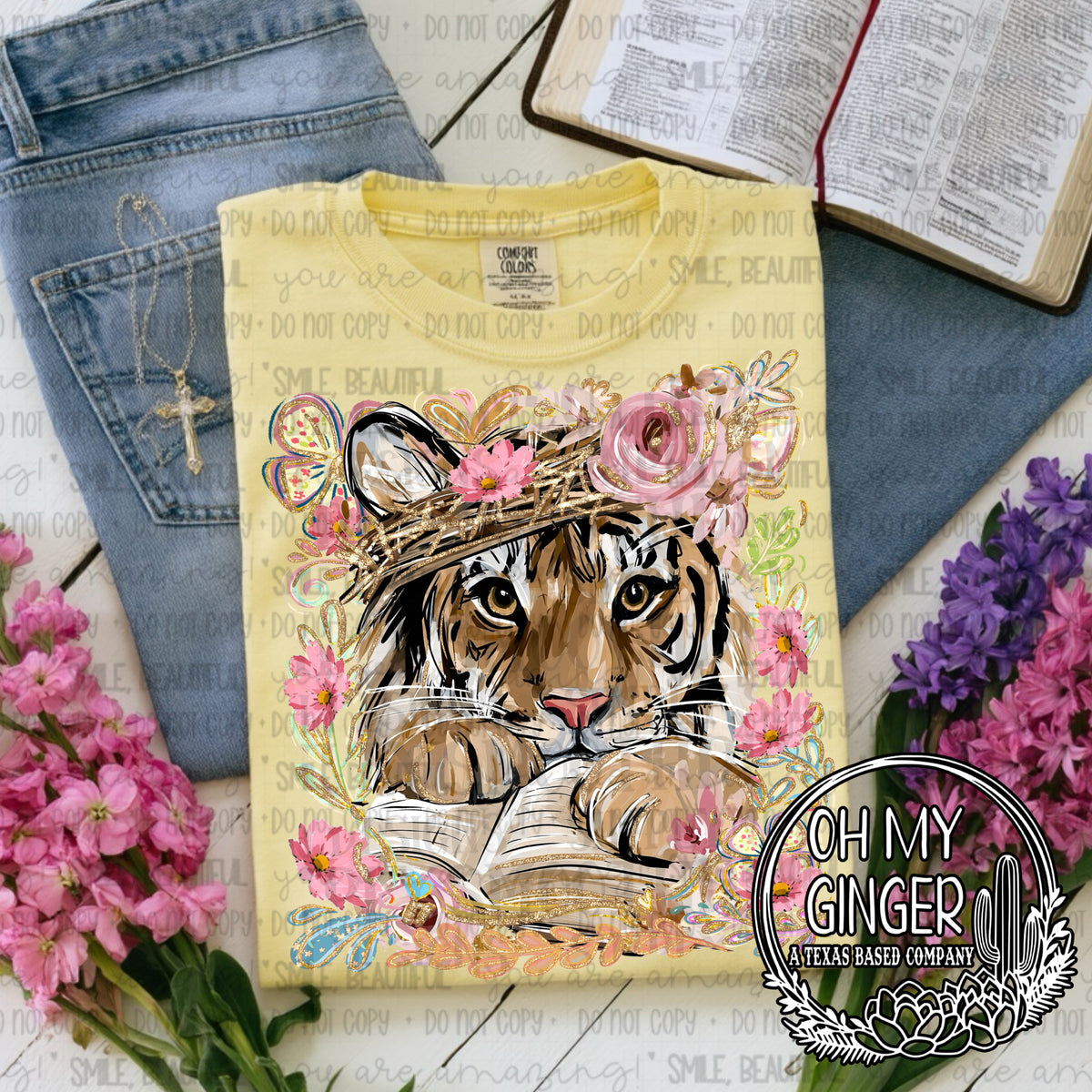 Tiger In A Bible — a tiger looking over a Bible with pink flowers