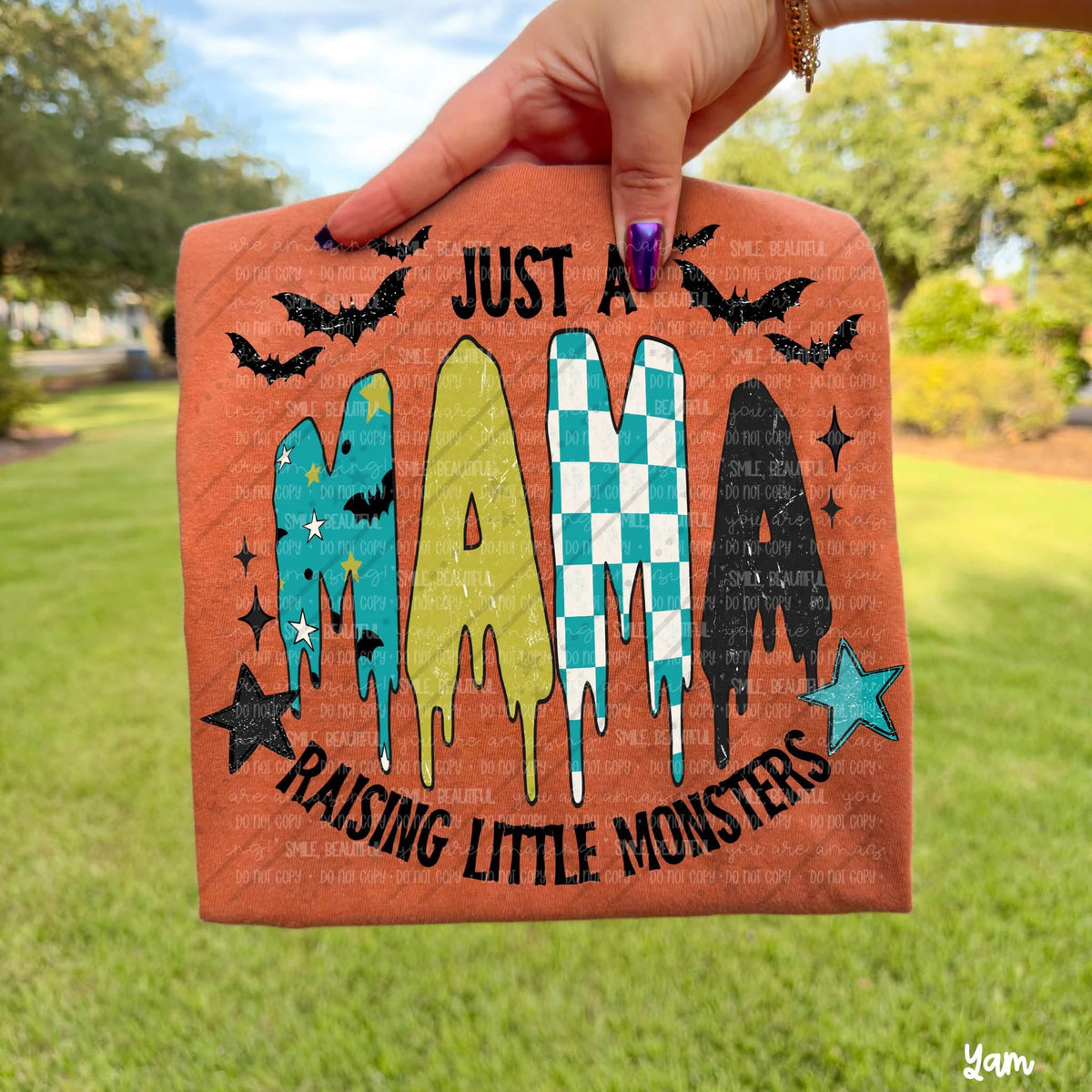 Just a Mama Raising Little Monsters design featuring bold Just a Mama Raising Little Monsters lettering with four dripping patterned monster shapes, black bats and colorful stars by Oh My Ginger