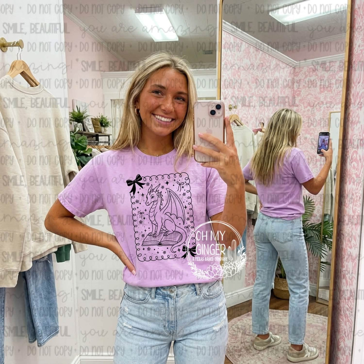 Dragon Frame Bow apparel mockup. An illustrated dragon sits inside an ornate decorative frame with a bow and small star accents.